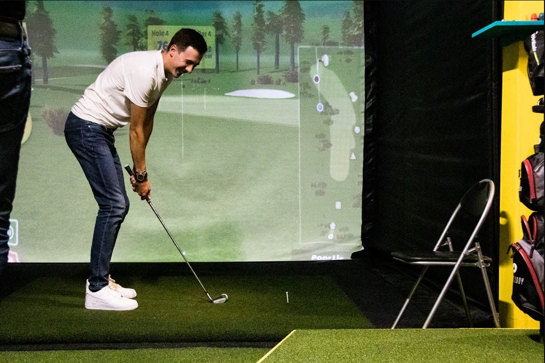 Home Simulator setup with impact projector screen, virtual golf, and player